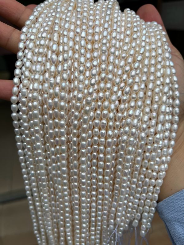 16-inch strands of 4mm white cultured rice-shaped freshwater pearls in bulk high luster - Image 3